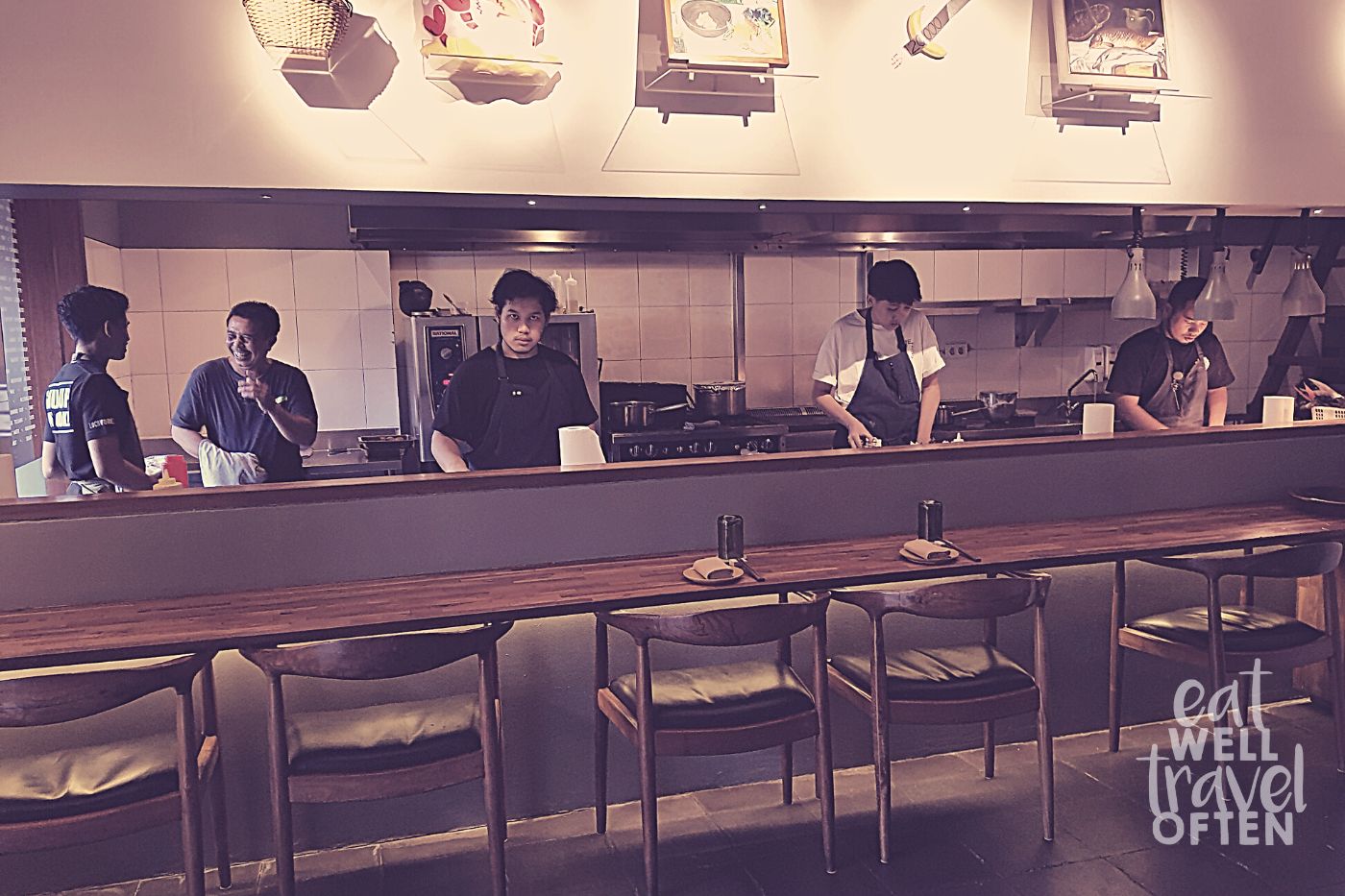 Several male chefs hard at work in the restaurant kitchen
